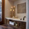 laser etched stone tiles create a soothing mandala at the back wall of the tub. the rest of the room is clad in a soft Venetian plaster. the drawer under the tub (far left) houses additional toiletries.